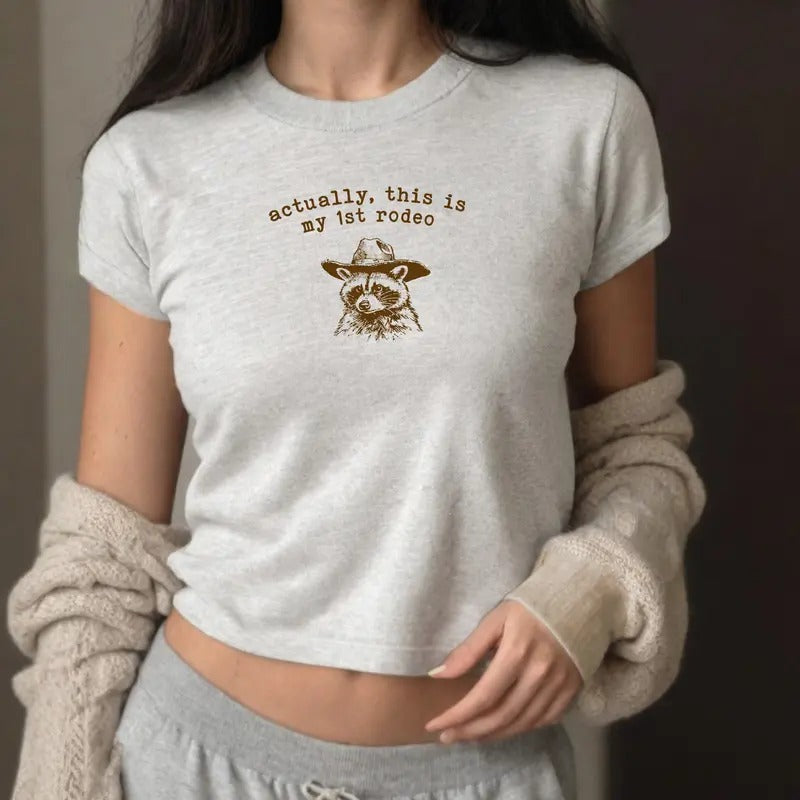 Actually This Is My First Rodeo Baby Tee - Y2K-style graphic tee with fun rodeo twist, perfect for casual wear. Hoodie,...