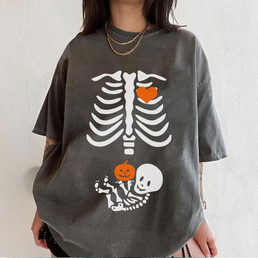 Comfort Color Skeleton Halloween Maternity T-Shirt, Funny Pregnancy Announcement 2025 TShirt, Spooky Pregnant Costume,...
