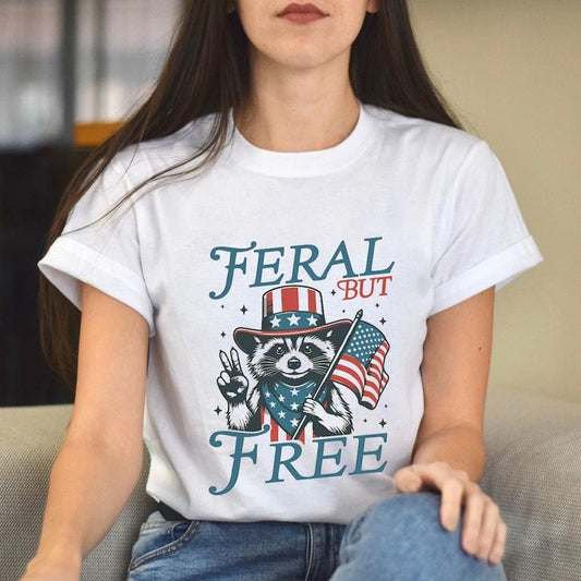 Feral But Free Funny Fourth of July Racoon TShirt, Patriotic Independence Day Gifts, USA Flag Print Unisex Cotton T-Shirt...