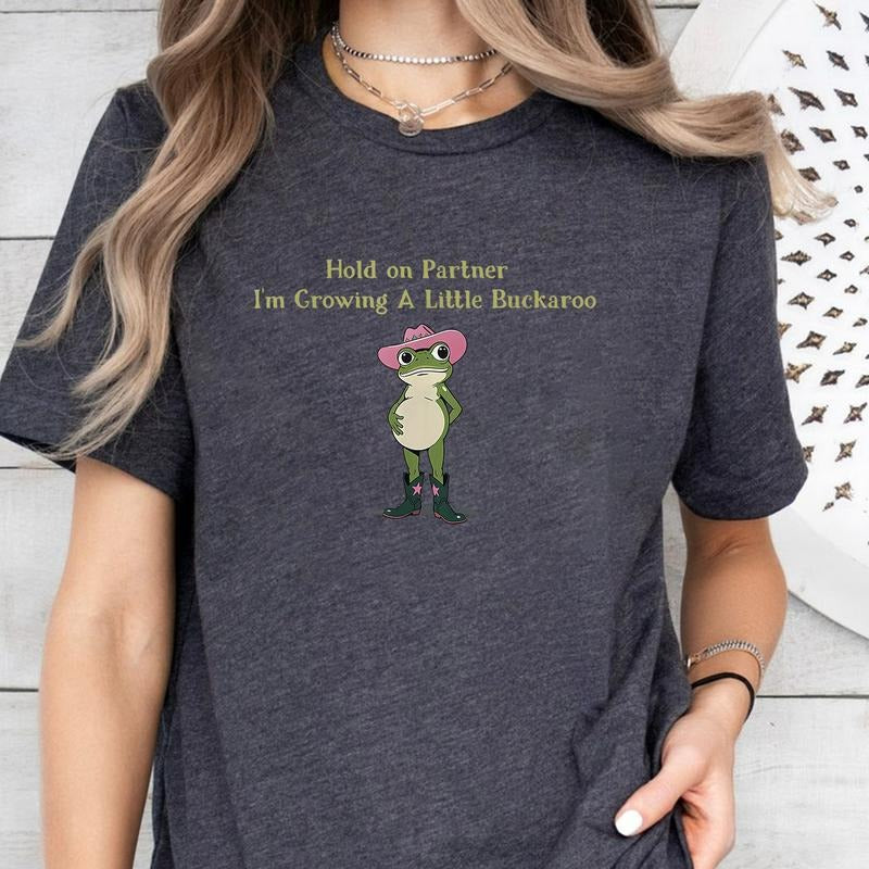 Hold On Partner I'm Growing A Little Buckaroo T-Shirt, Cute Animal T-Shirt, Funny Frog T-Shirt, Unhinged T-Shirt,...