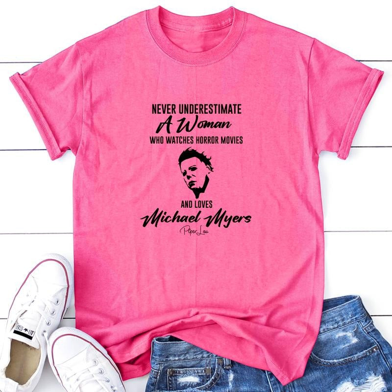 Never Underestimate A Woman Who Watches Horror Movies Apparel, Printed In The USA, Tee / Tank / V Neck Gray / White /...