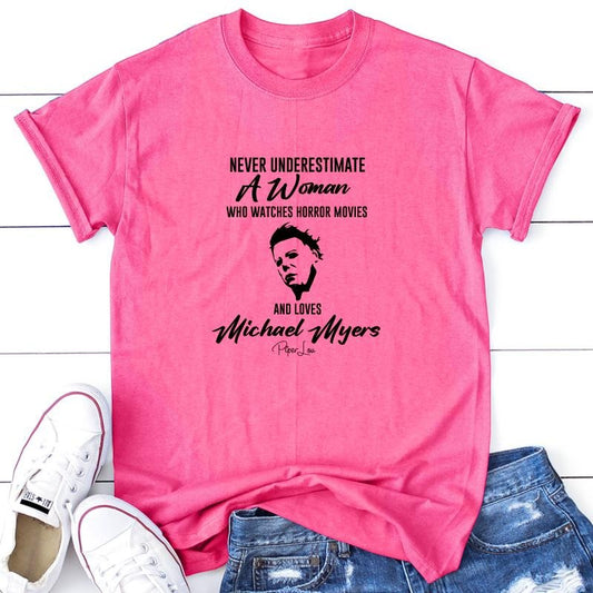 Never Underestimate A Woman Who Watches Horror Movies Apparel, Printed In The USA, Tee / Tank / V Neck Gray / White /...