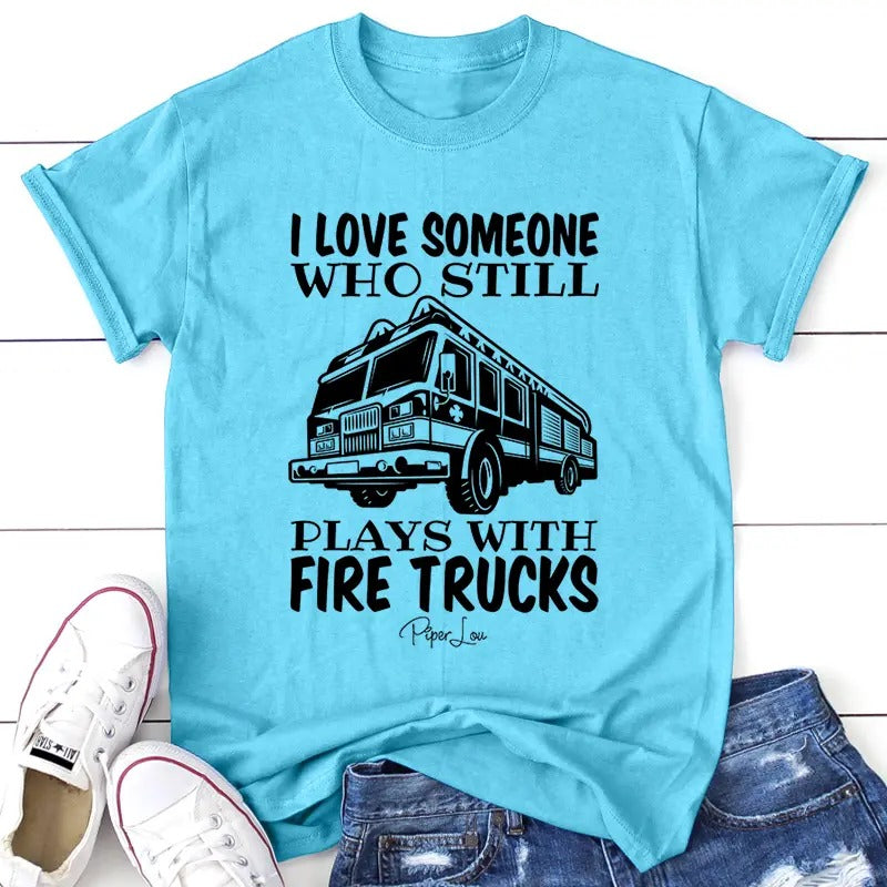 I Love Someone Who Still Plays With Firetrucks Apparel, Printed In The USA, Tee / Tank / V Neck Gray / White / Blue / Hot...