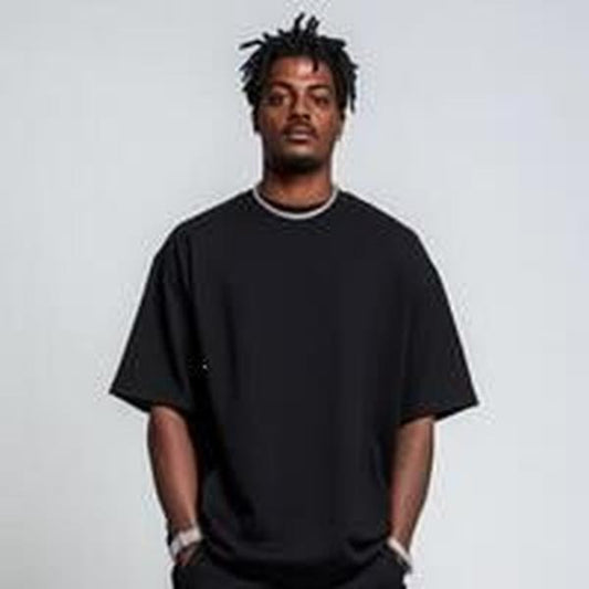 fashion-model-in-oversized-black-t-shirt-against-minimalistic-studio-background-photo T-Shirt Cotton with Graphic Print...
